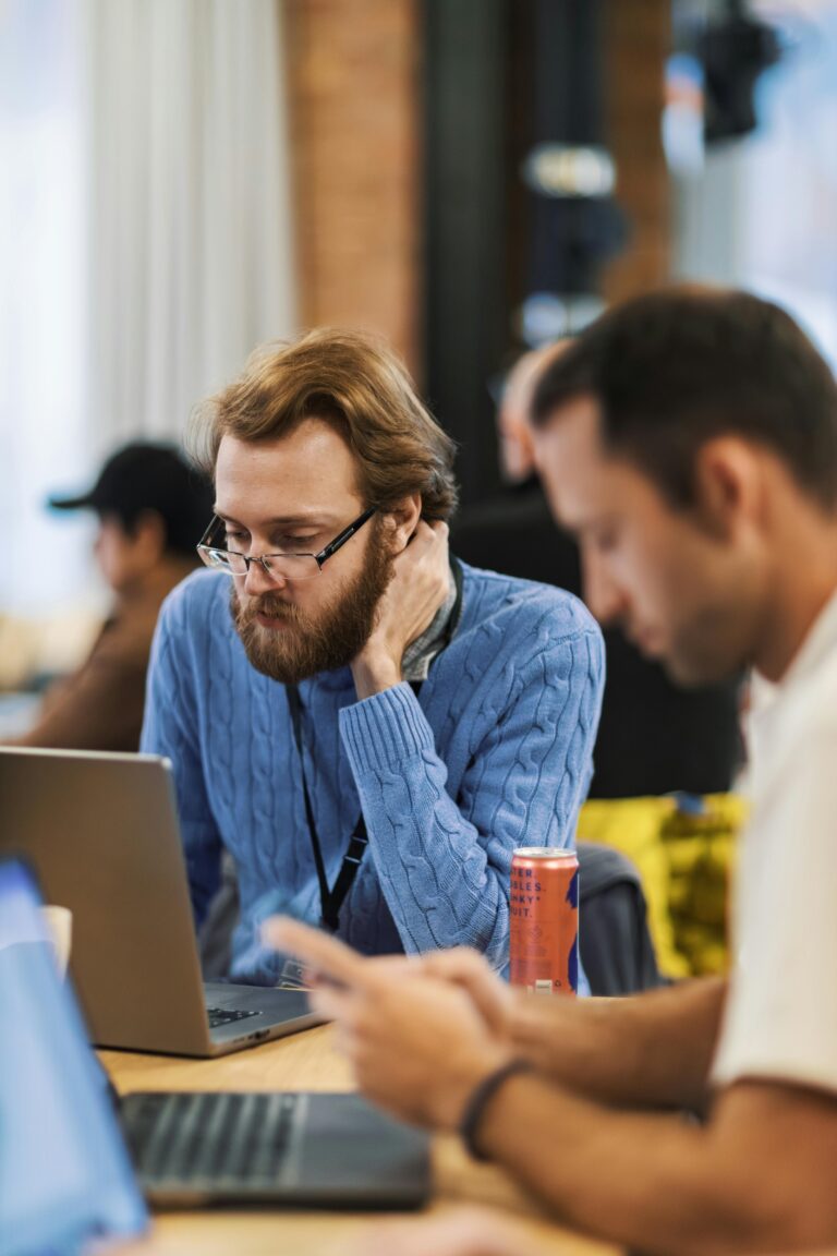 Focused professionals collaborating in a modern office setting, highlighting teamwork and technology.